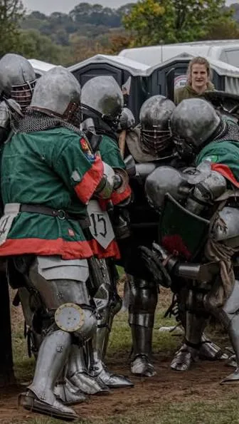 Group of Armored League fighters in a live bout at an outdoor tournament